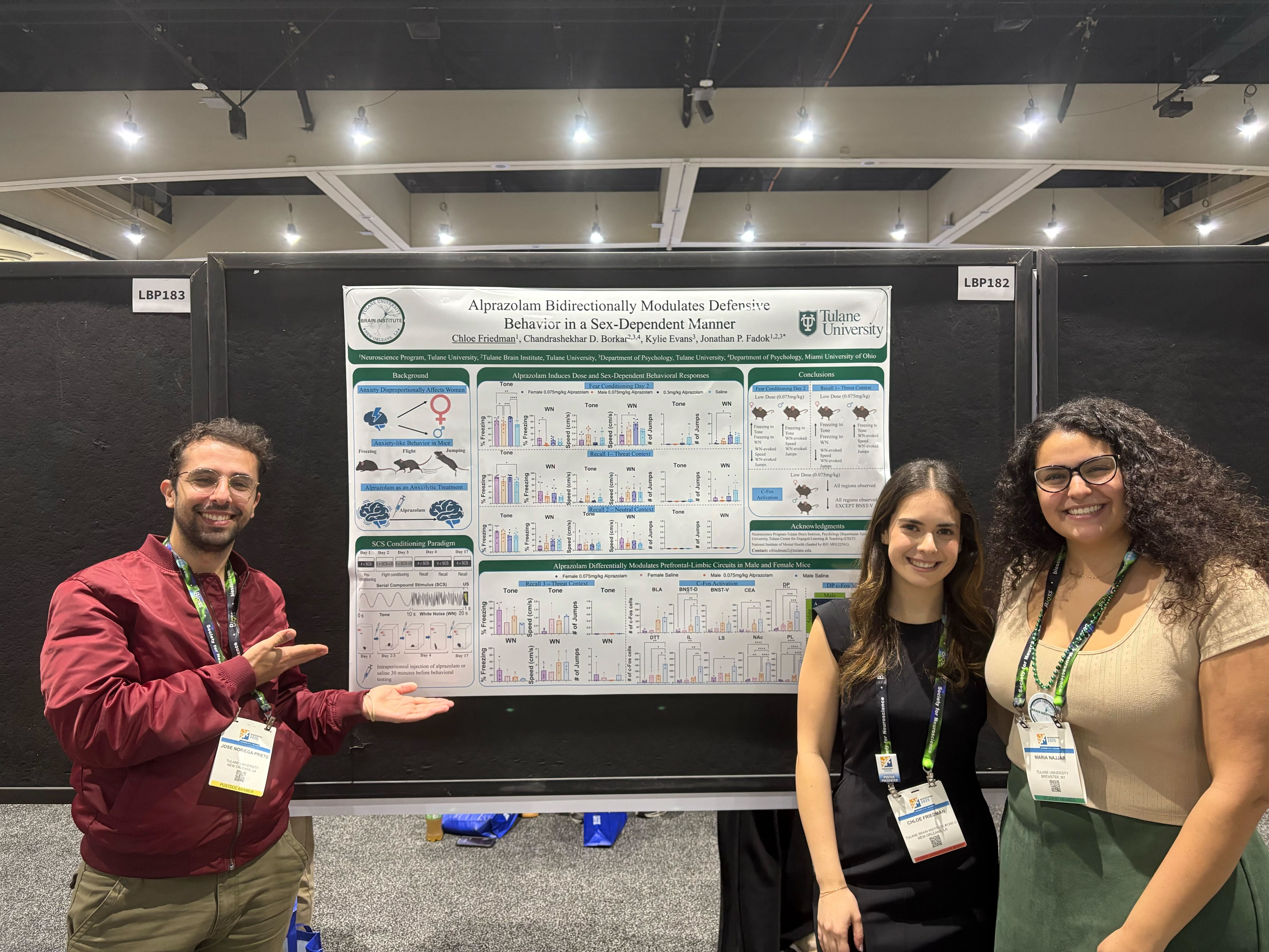 Jose, Chloe, and Maria stand next to Jose's Poster at SfN