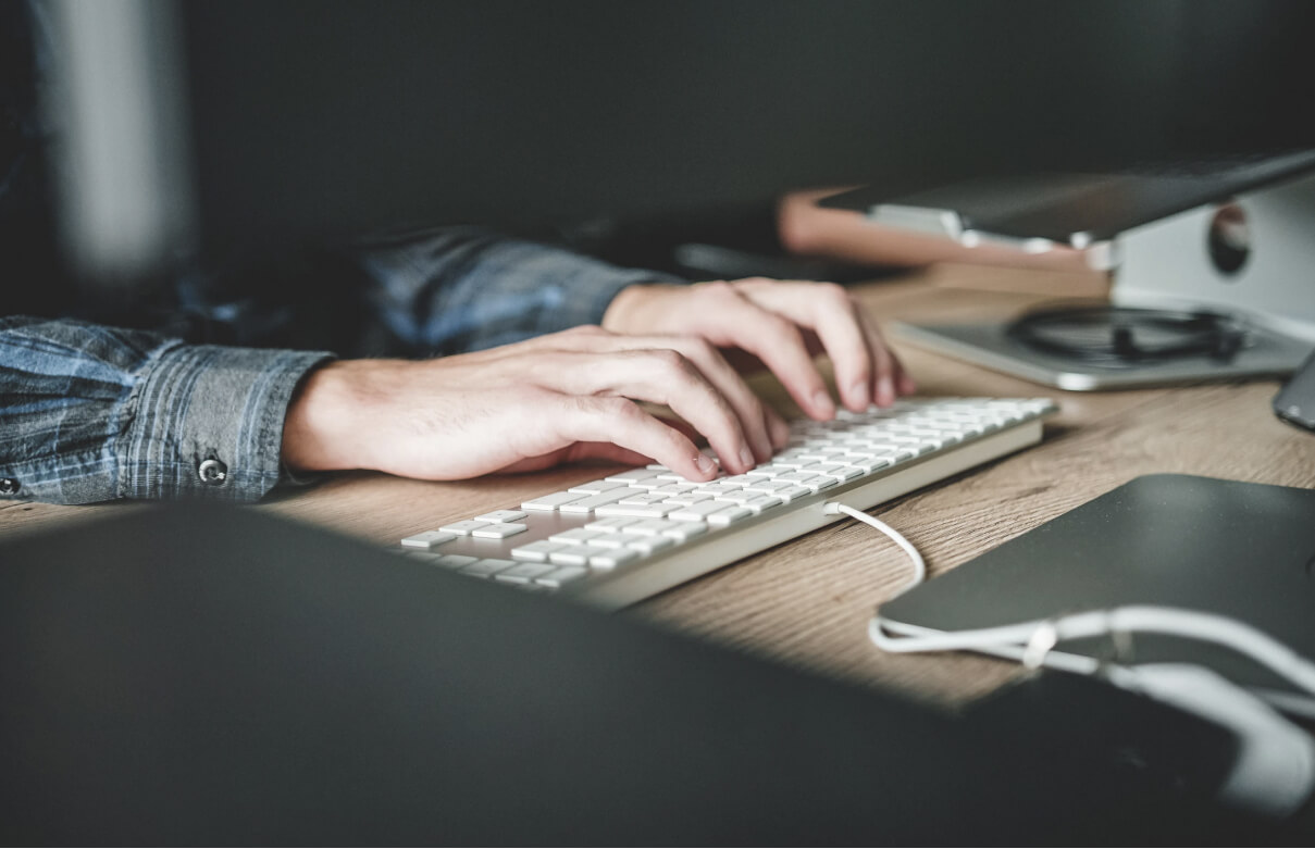 hands typing on a keyboard