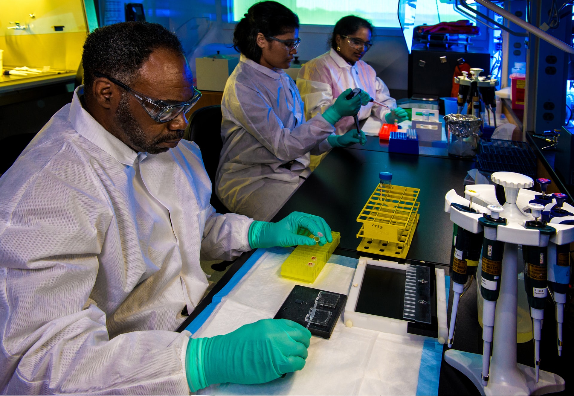 Researcher filling yellow container in laboratory
