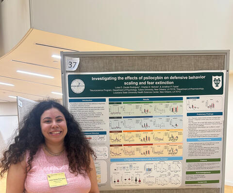 Luisa standing in front of her poster at GRC