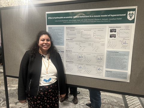 Luisa standing in front of her poster at ISRP