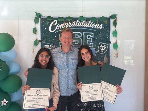Yumnah and Chloe standing next to Dr. Fadok with their awards