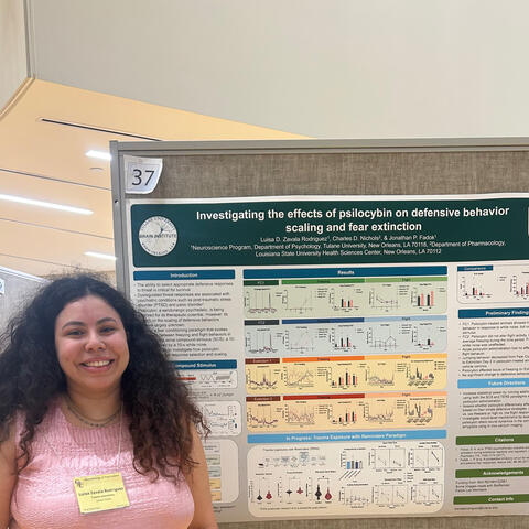 Luisa standing in front of her poster at GRC