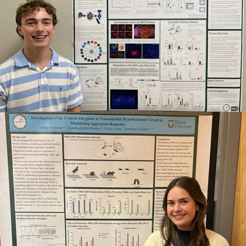 Chloe and Owen Stand and smile by their posters