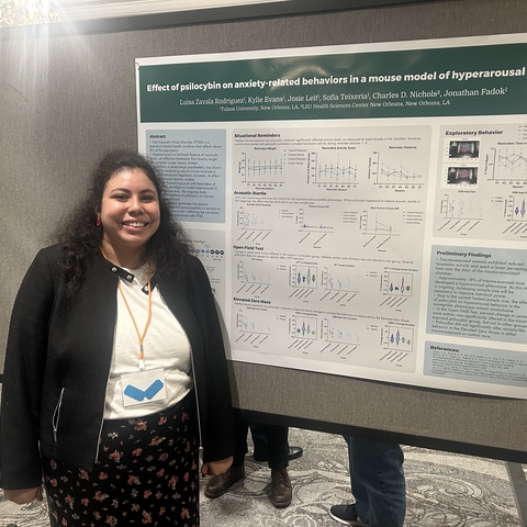 Luisa standing in front of her poster at ISRP