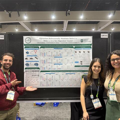 Jose, Chloe, and Maria stand next to Jose's Poster at SfN
