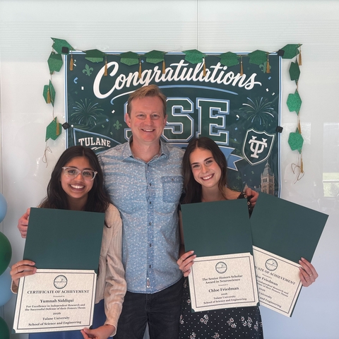 Yumnah and Chloe standing next to Dr. Fadok with their awards