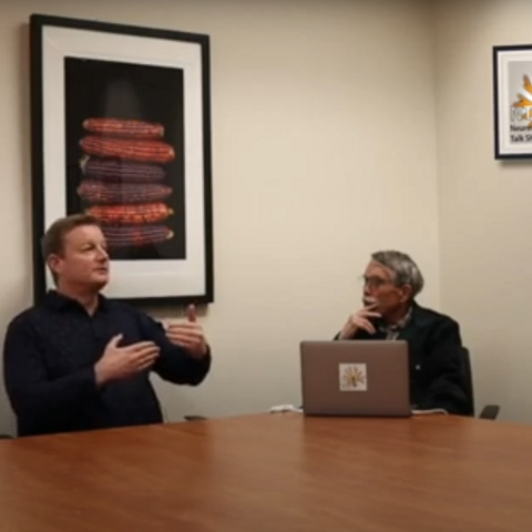 Dr. Fadok describing something with his hands while speaking on the Neuroscientists Talk Shop Podcast