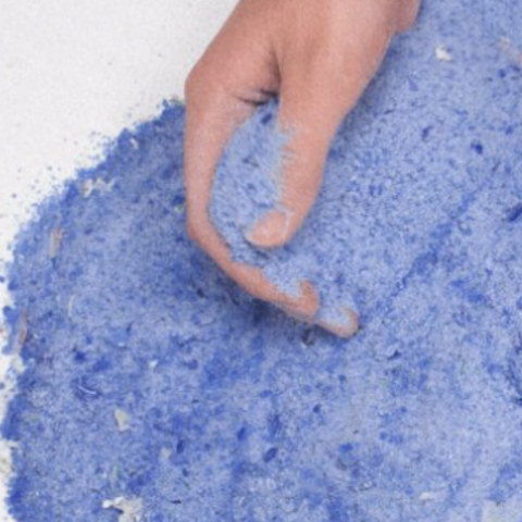 hand in glass sand